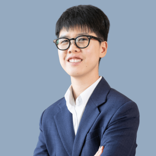 Headshot of someone wearing a suit and glasses.
