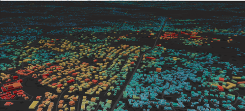 A rendering of buildings with a heatmap overlaid on top of them that shows electricity use in different buildings. The cast of the image is black and the buildings appear in a range of colors from blue to red.